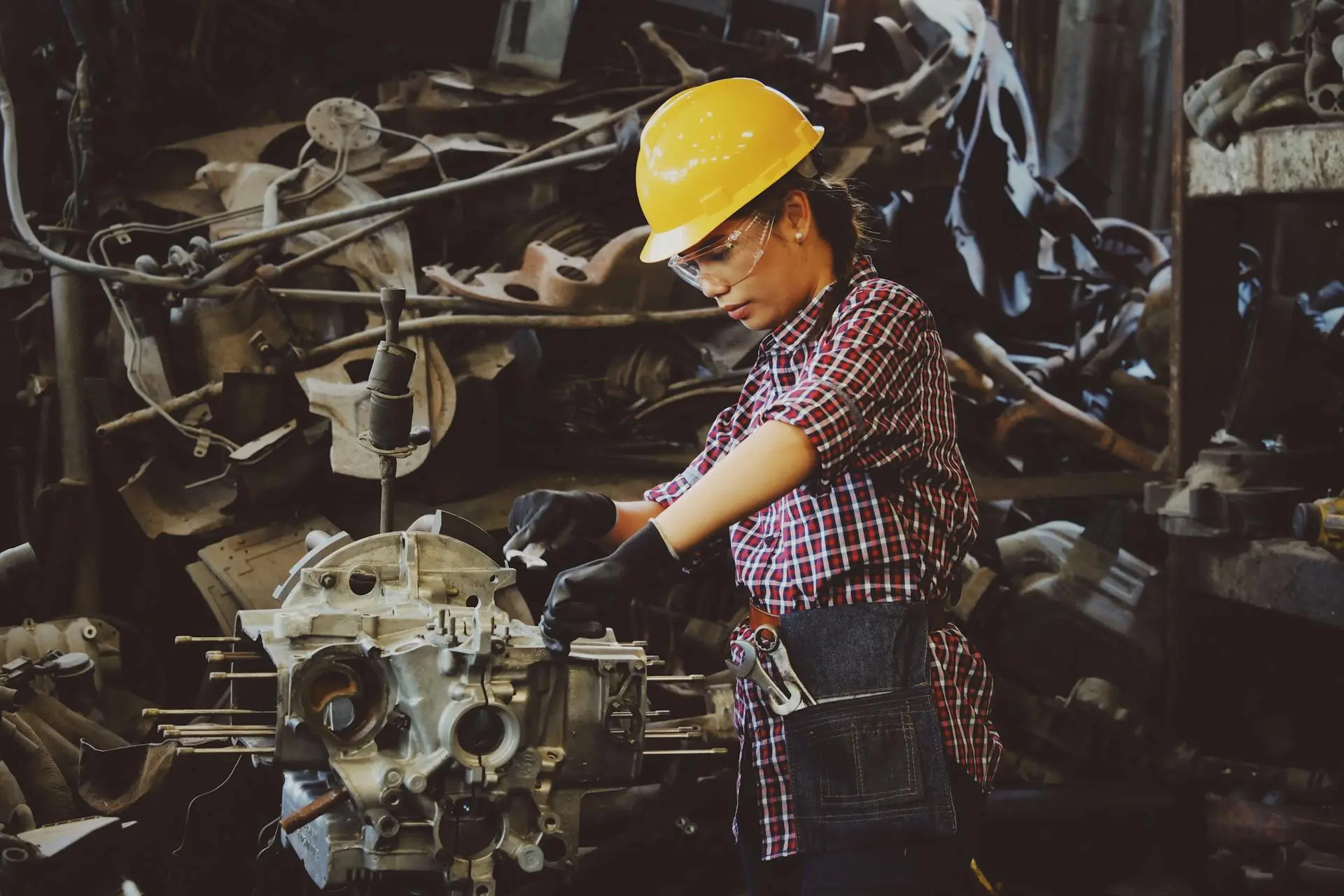 Female engineer at work fixing engine