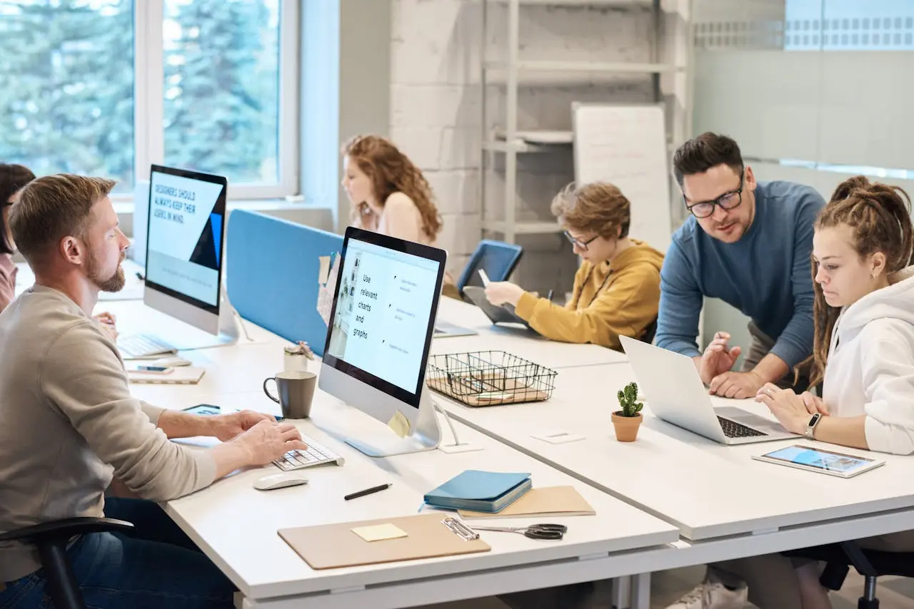 Office staff sitting at desks talking